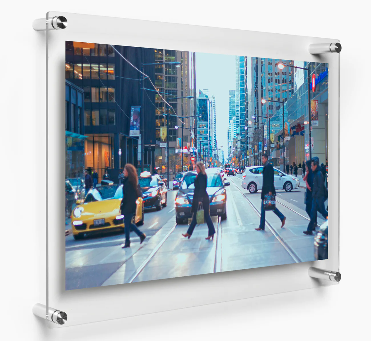 A clear panel frame displaying a landscape photograph of a busy street and people walking across it